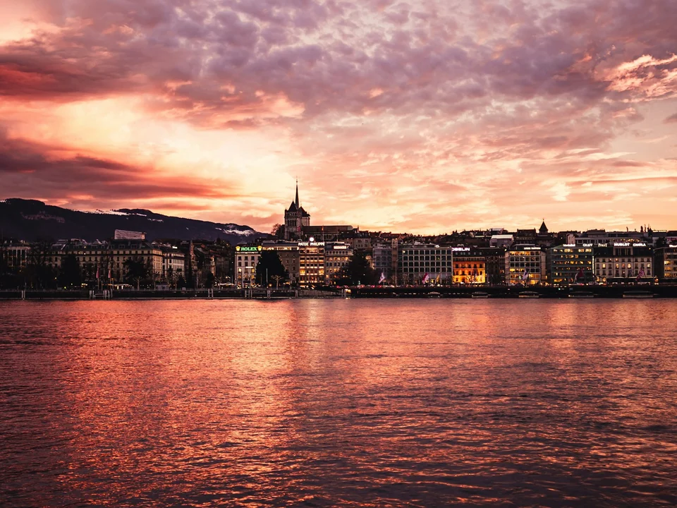 Geneva's waterfront and old town at sunset.